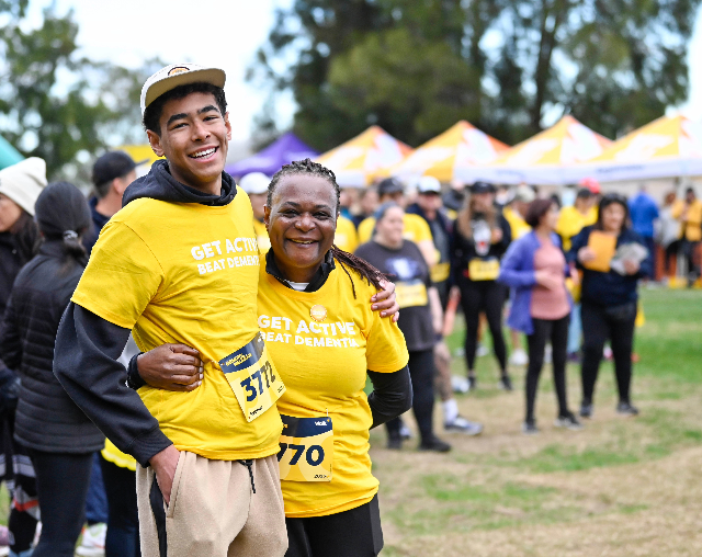 Memory Walk & Jog. Two people standing hugging at the start of the race.