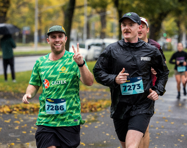 Memory Walk & Jog, Two men running in light rain in a park